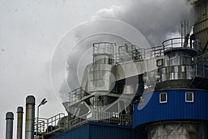 Steam coming out of an industrial facility, factory. Air pollution caused by smoke from the factoryÃ¢â¬â¢s chimney.